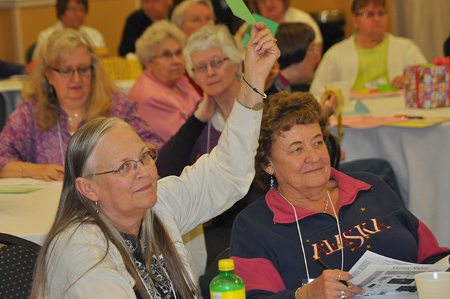 Voting members practice voting for the delegate's meeting.